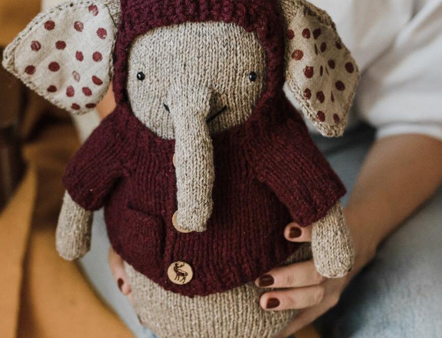 Woman Holding A Knitted Stuff Toy