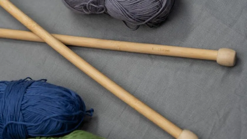 Blue And Green Yarn On White Textile