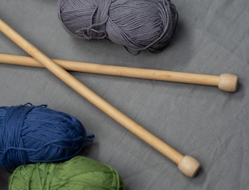 Blue And Green Yarn On White Textile
