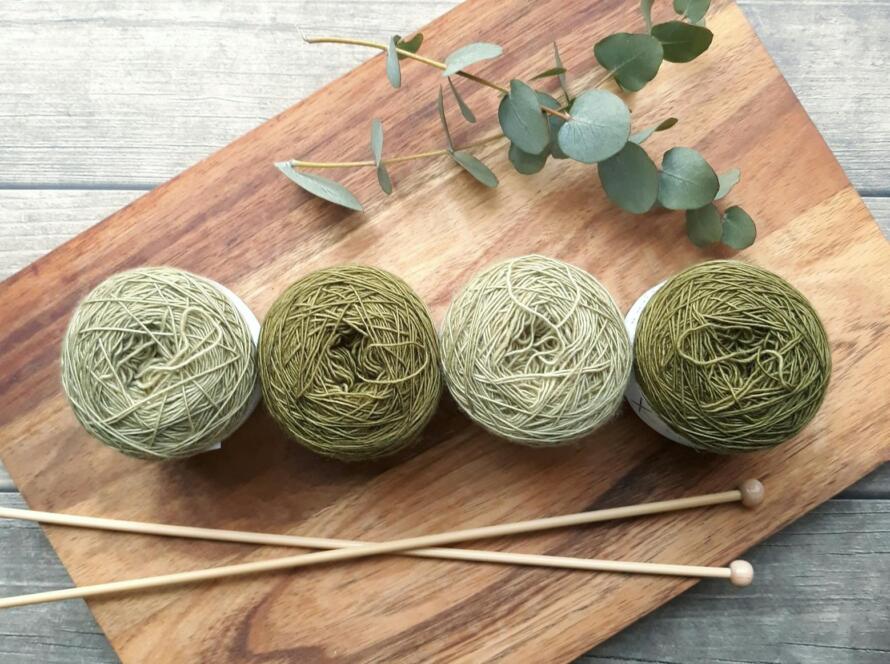 Four Green Yarns On Chopping Board